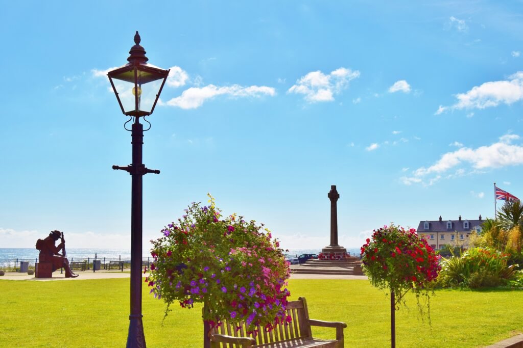 Seaham seafront green with a lamp post and colourful hanging baskets