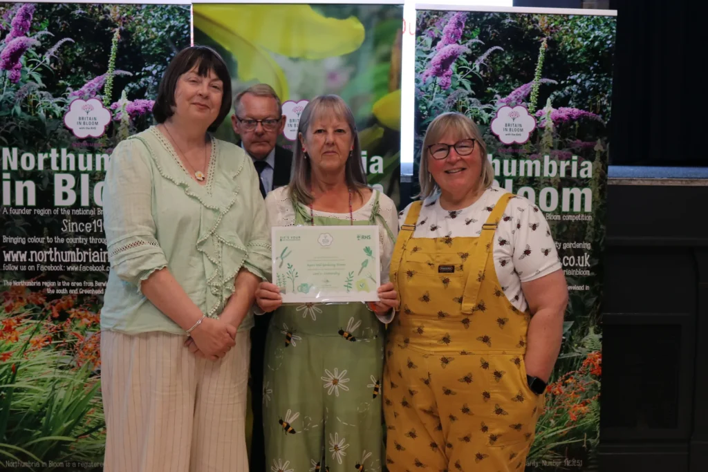 Volunteers holding their certificates at the 2026 presentation of awards