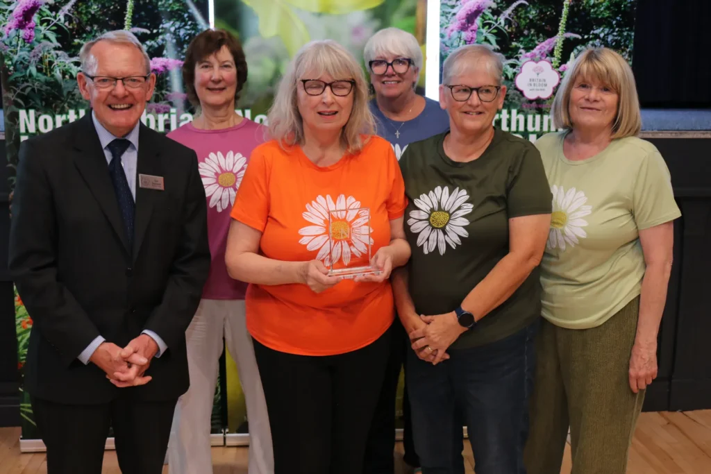 A community group celebrating their award at the 2026 presentation of awards